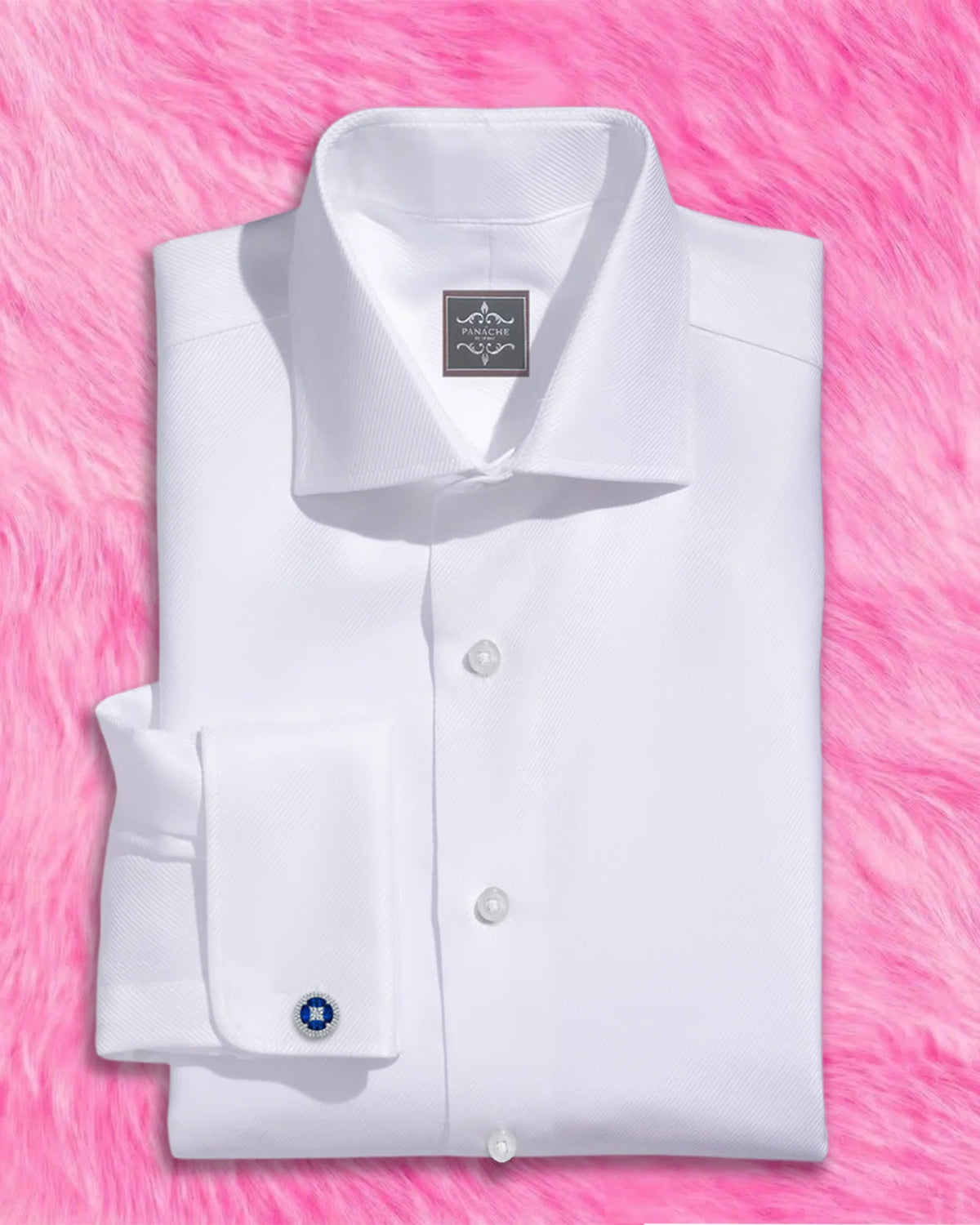White twill French cuff dress shirt for men with a wide spread collar and French placket, folded with a cufflink